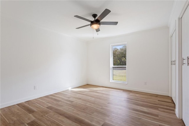 spare room featuring ceiling fan, ornamental molding, and light hardwood / wood-style flooring