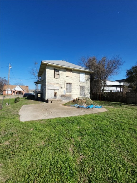 back of property with a yard and a patio area