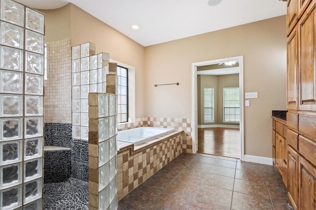 bathroom featuring tile patterned floors and separate shower and tub