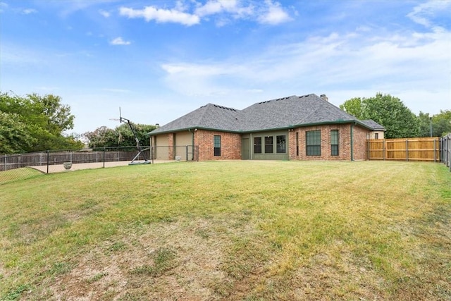 rear view of property with a yard