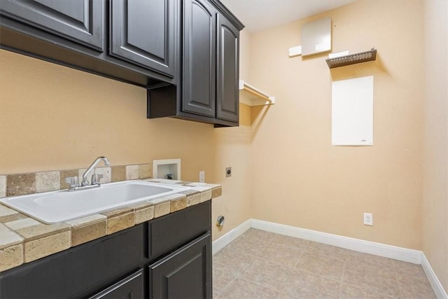 laundry area featuring sink, hookup for an electric dryer, cabinets, and washer hookup