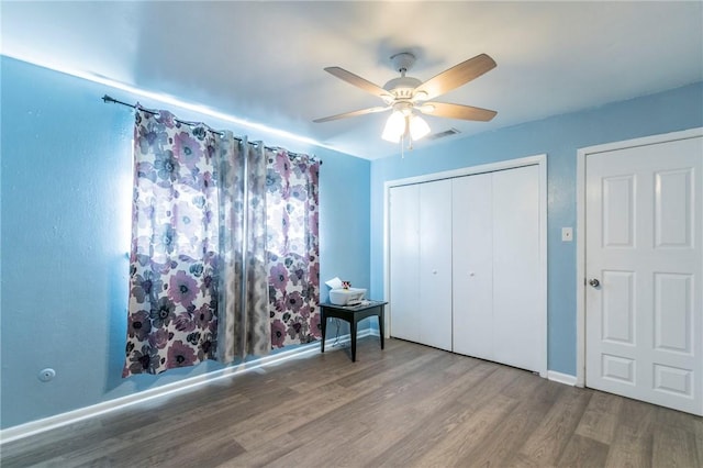 unfurnished bedroom with hardwood / wood-style flooring and ceiling fan