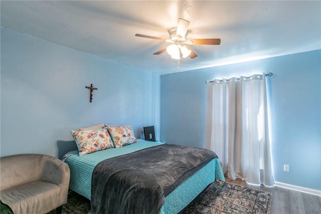 bedroom featuring hardwood / wood-style flooring and ceiling fan