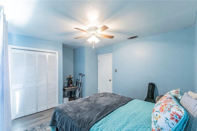 bedroom with wood-type flooring, a closet, and ceiling fan