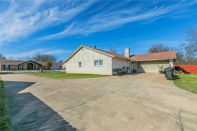 view of property exterior with a lawn and a garage