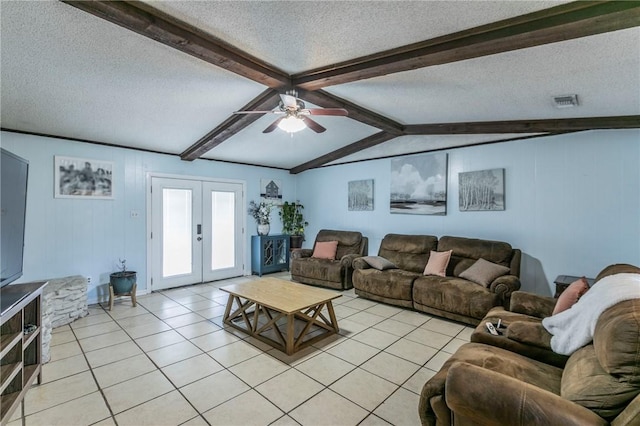 living room featuring french doors, a textured ceiling, ceiling fan, light tile patterned floors, and lofted ceiling with beams