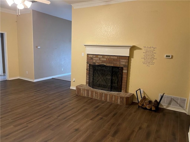 unfurnished living room featuring crown molding, ceiling fan, dark hardwood / wood-style floors, and a brick fireplace