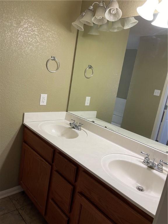 bathroom with tile patterned floors and vanity