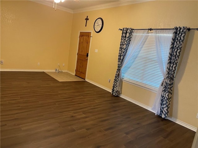 spare room with crown molding and dark wood-type flooring