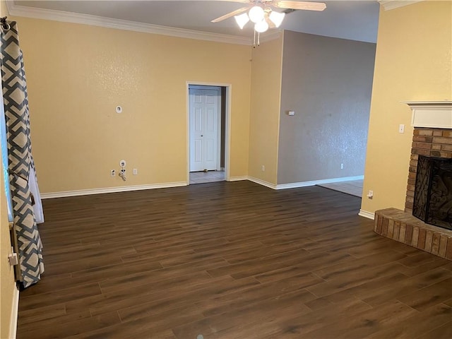 unfurnished living room featuring a fireplace, ornamental molding, ceiling fan, and dark wood-type flooring