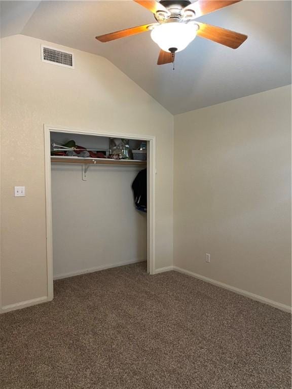 unfurnished bedroom featuring carpet flooring, ceiling fan, a closet, and vaulted ceiling