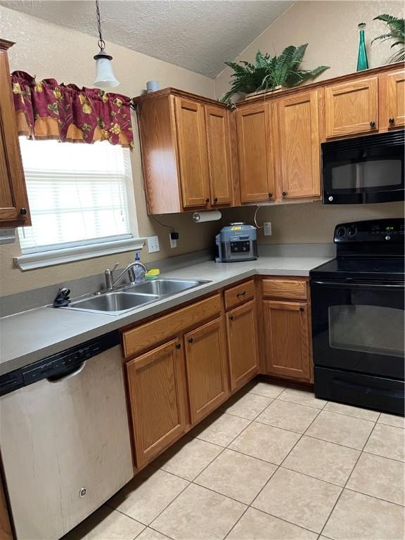 kitchen featuring sink, hanging light fixtures, a textured ceiling, light tile patterned floors, and black appliances