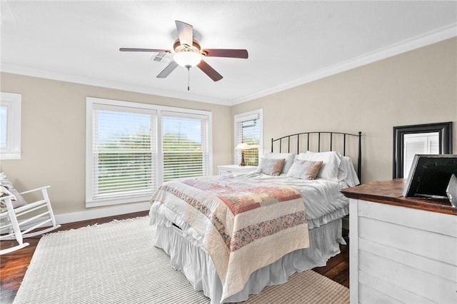 bedroom with ceiling fan, dark wood-type flooring, and ornamental molding