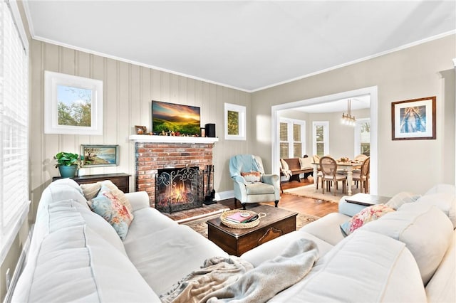 living room featuring hardwood / wood-style floors, ornamental molding, and a fireplace