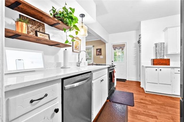 kitchen featuring appliances with stainless steel finishes, light stone counters, decorative light fixtures, light hardwood / wood-style flooring, and white cabinets