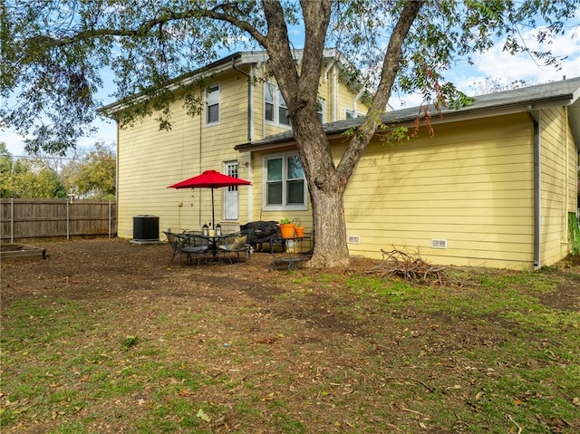 rear view of property featuring central AC