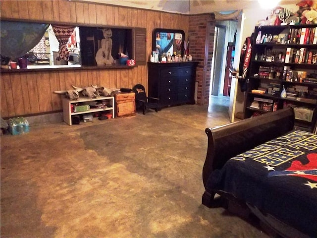 bedroom with wood walls and concrete flooring