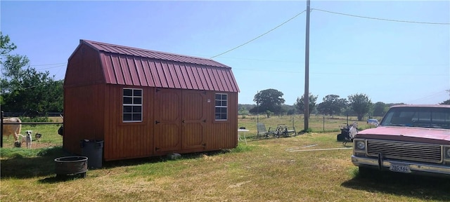 view of outbuilding featuring a lawn