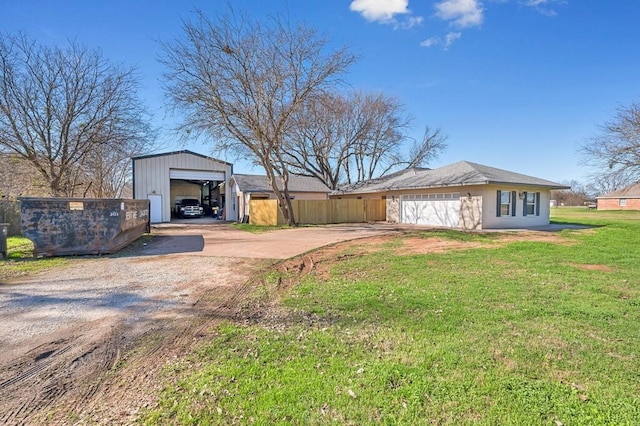 exterior space featuring an outbuilding, a yard, and a garage