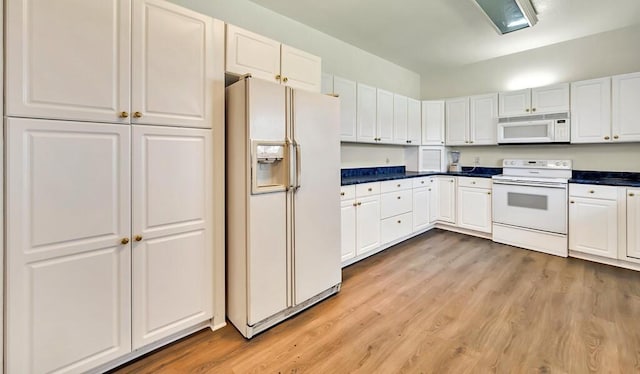 kitchen featuring white appliances, light hardwood / wood-style flooring, and white cabinetry