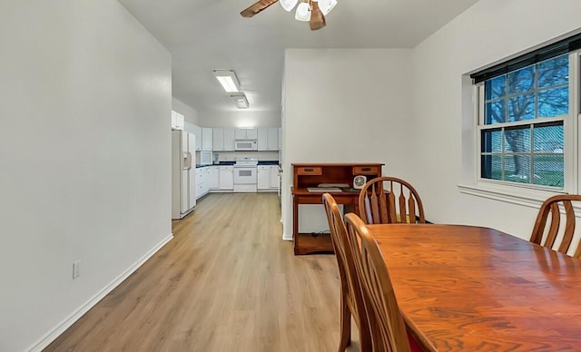 dining space with light hardwood / wood-style flooring and ceiling fan