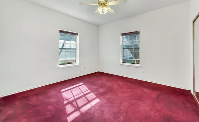 carpeted empty room featuring ceiling fan