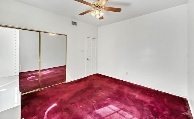 unfurnished bedroom with carpet floors, a closet, and ceiling fan