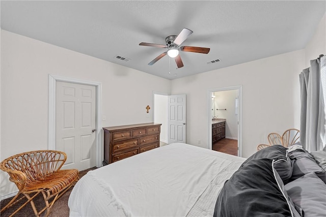 bedroom with ensuite bath and ceiling fan