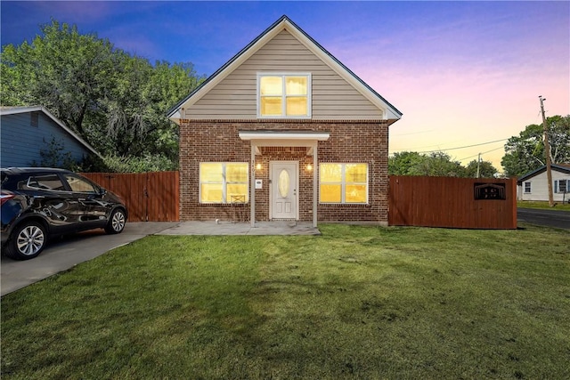 front of property with a patio area and a lawn