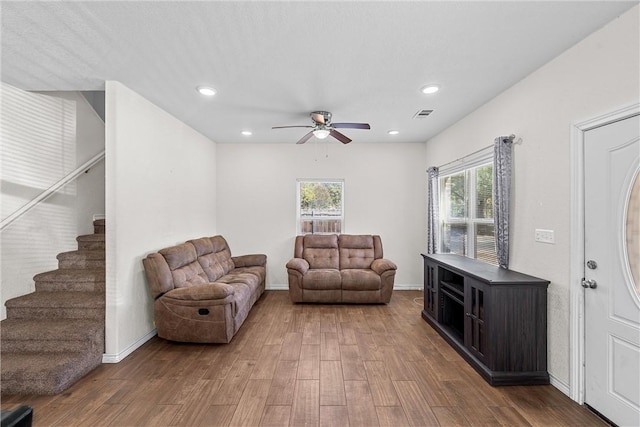 living area with dark hardwood / wood-style flooring and ceiling fan