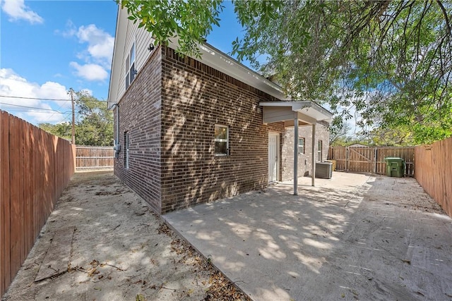 view of property exterior featuring a patio area and central AC