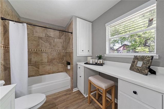 full bathroom featuring hardwood / wood-style flooring, vanity, toilet, and shower / tub combo with curtain