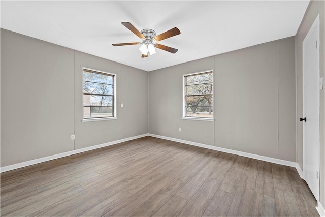 spare room with light wood-type flooring and ceiling fan