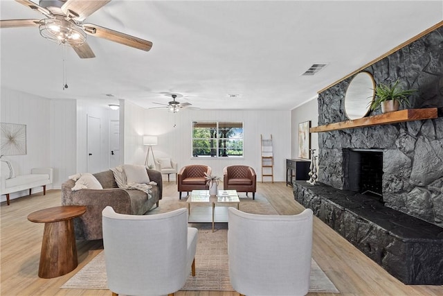 living room with a fireplace and light hardwood / wood-style flooring