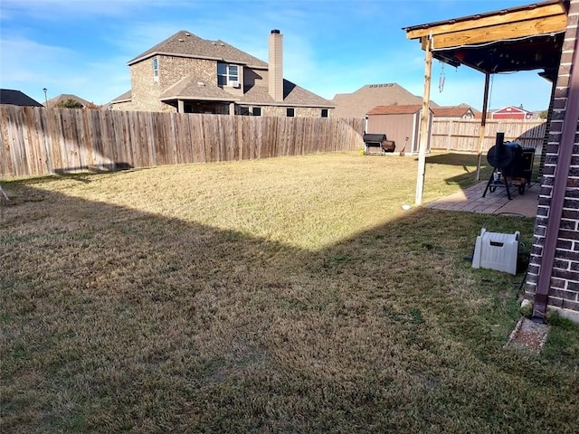 view of yard featuring a shed and a patio