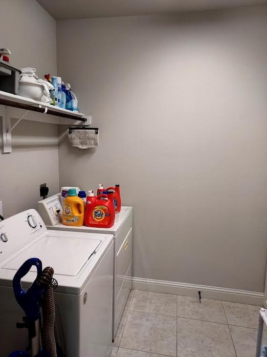 washroom featuring light tile patterned floors and washing machine and clothes dryer