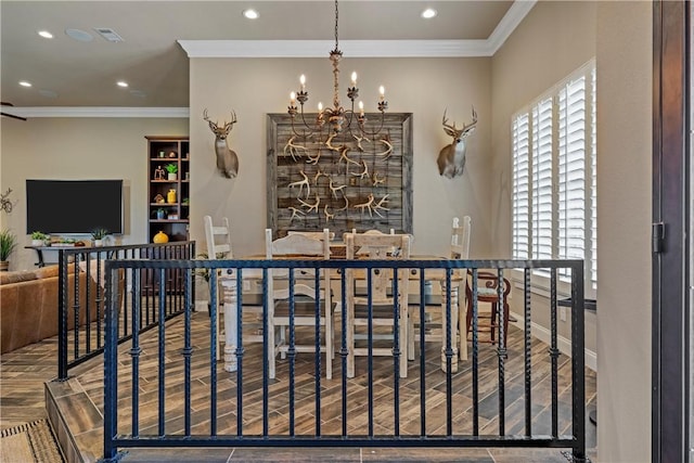 dining space featuring a notable chandelier, wood finish floors, and ornamental molding