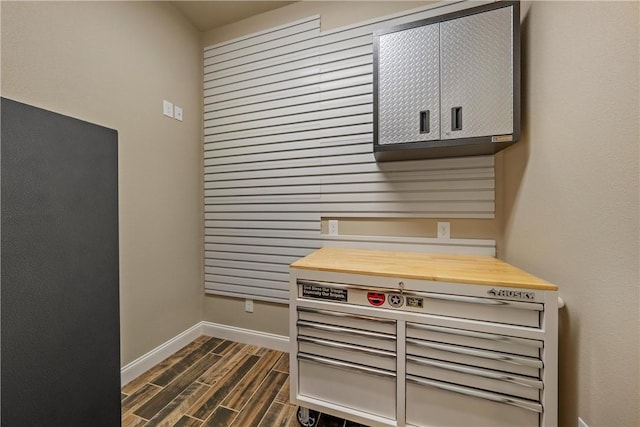 interior details featuring baseboards and wood finish floors