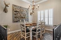 dining space featuring ornamental molding and hardwood / wood-style floors