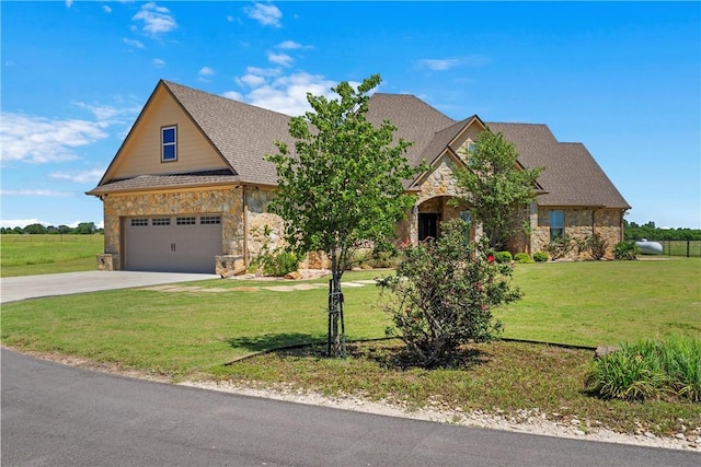 view of front of home with stone siding, roof with shingles, concrete driveway, a front yard, and a garage