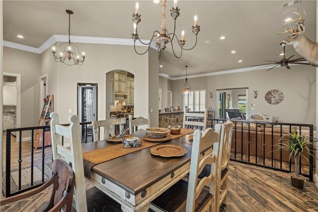 dining area featuring ceiling fan with notable chandelier, crown molding, recessed lighting, and wood finished floors