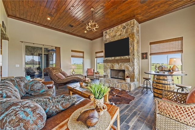 living room featuring dark wood finished floors, wood ceiling, ornamental molding, a fireplace, and an inviting chandelier