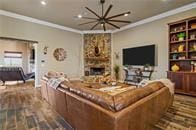 living room featuring ornamental molding, hardwood / wood-style floors, and a notable chandelier