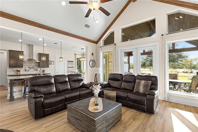 living room with french doors, ceiling fan, high vaulted ceiling, and light hardwood / wood-style flooring