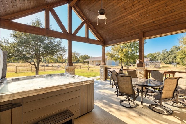 view of patio / terrace with a hot tub, a gazebo, and ceiling fan