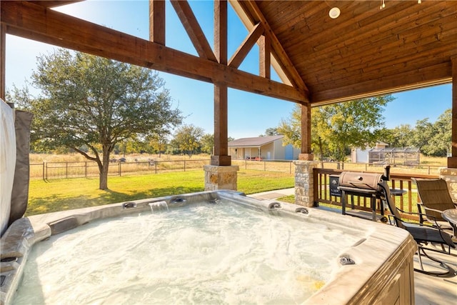 view of patio / terrace featuring a rural view and a hot tub