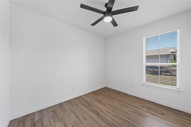 empty room featuring light hardwood / wood-style floors, ceiling fan, and a healthy amount of sunlight