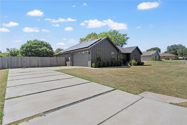 view of home's exterior with solar panels, a yard, and a garage