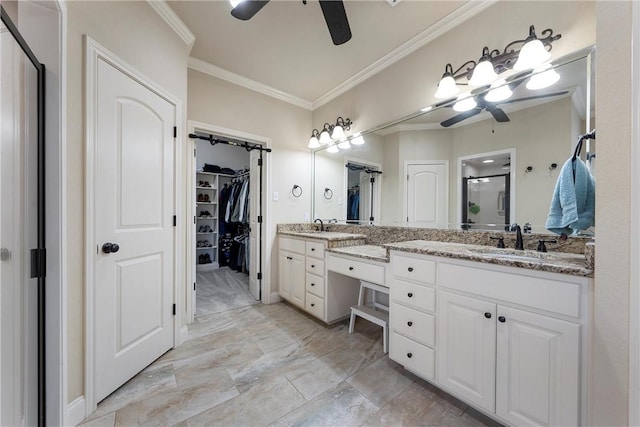 bathroom featuring vanity, a ceiling fan, a shower stall, a walk in closet, and crown molding