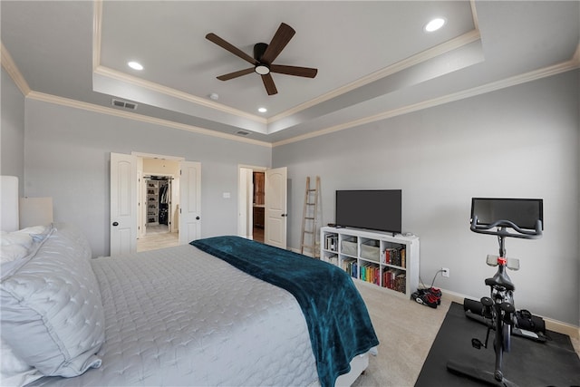 carpeted bedroom with a raised ceiling, baseboards, and visible vents